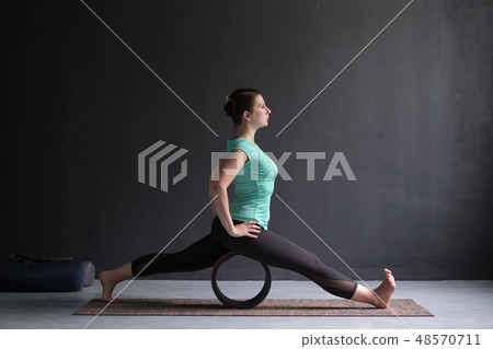Young woman doing yoga or pilates exercise. Young woman doing yoga or pilates exercise. 48570711