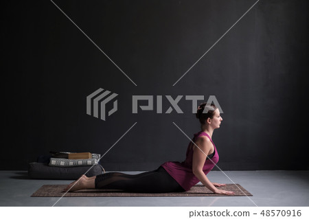 Woman practicing yoga, doing Cobra exercise 48570916
