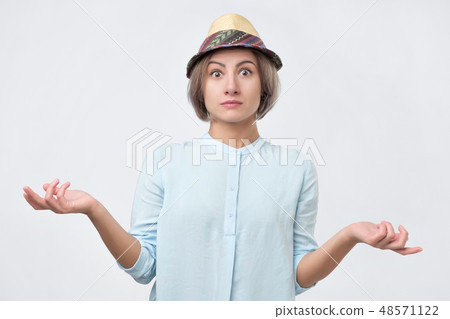 Young girl shrugging shoulders.   48571122