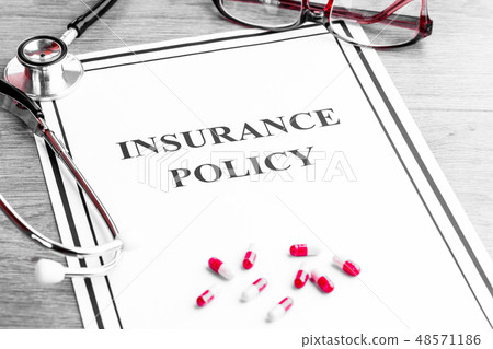 Health Insurance Policy. Stethoscope, Glasses, Dollars on Table 48571186