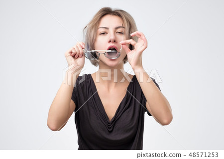 Woman wiping her glasses cleaning them dust. Woman wiping her glasses cleaning them dust. 48571253