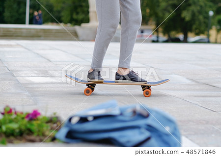 young woman study skateboarding at city. young woman study skateboarding at city. 48571846