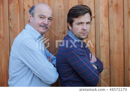 Father and son stand together 48572279