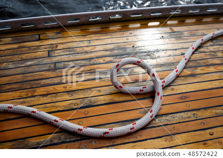 yellow wooden deck with rope 48572422