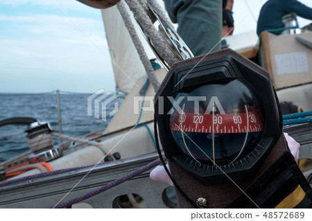 Compass on yacht boat a blue summer sea ocean day Compass on yacht boat a blue summer sea ocean day 48572689