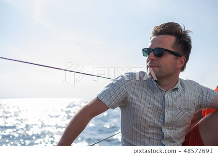 sailor relaxing happily on sailboat yacht sailor relaxing happily on sailboat yacht 48572691
