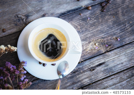 Coffee cup and dry flower on wood. Coffee cup and dry flower on wood. 48573133