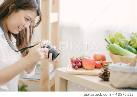 woman using camera Taking pictures to vegetables woman using camera Taking pictures to vegetables 48573152