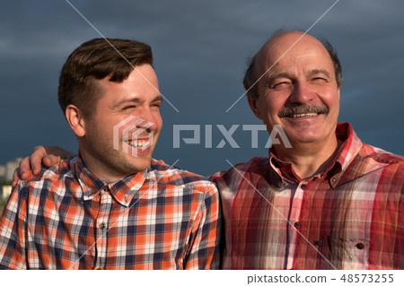 portrait of happy father and son walking outdoors. 48573255