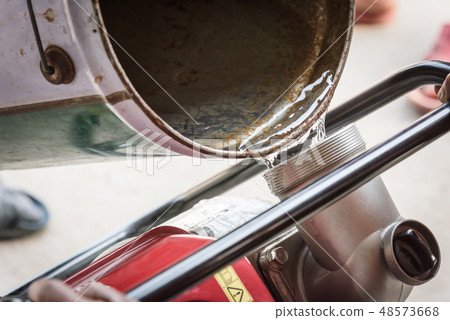 Farmer fill water into water pump engine 48573668
