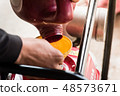 Farmer fill fuel into water pump engine 48573671