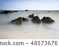Beautiful rocky sea beach at the sunset 48573676