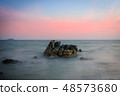 Beautiful rocky sea beach at the sunset 48573680