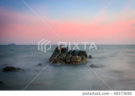 Beautiful rocky sea beach at the sunset 48573680