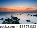 Beautiful rocky sea beach at the sunset 48573682