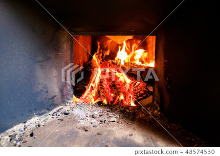 Burning logs in a fireplace at old house Burning logs in a fireplace at old house 48574530