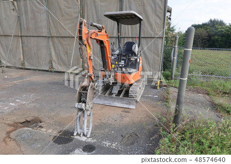 Mini excavator and demolition work site 48574640