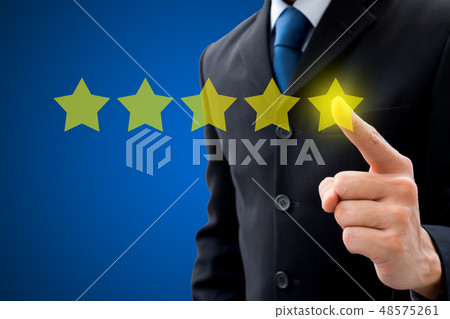 Businessman pushing on five stars for best rating. Businessman pushing on five stars for best rating. 48575261