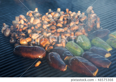 Mushroom barbecue roasted on metal grill. Diet vegan bbq. Fungi kebab closeup at picnic outdoors Mushroom barbecue roasted on metal grill. Diet vegan bbq. Fungi kebab closeup at picnic outdoors 48575308