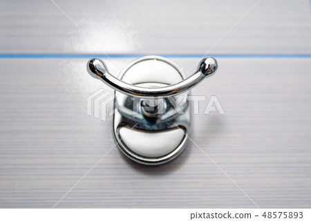 Stainless steel towel hanger on wall in bathroom 48575893