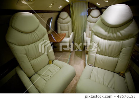 Luxury interior in bright colors of genuine leather in the business jet 48576155