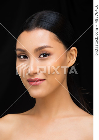 Asian Woman after applying make up hair style 48576416