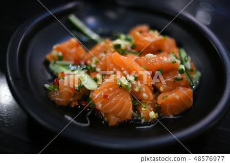Salmon salad on black plate Salmon salad on black plate 48576977