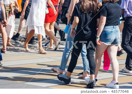 pedestrians at a pedestrian crossing 48577046