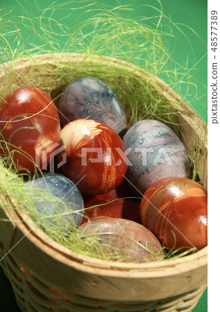 Painted eggs on green background. 48577389