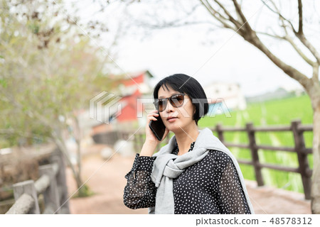 woman talking on mobile phone woman talking on mobile phone 48578312