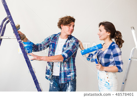 People, renovation and repair concept - Portrait of lovely couple doing redecoration in apartment People, renovation and repair concept - Portrait of lovely couple doing redecoration in apartment 48578401