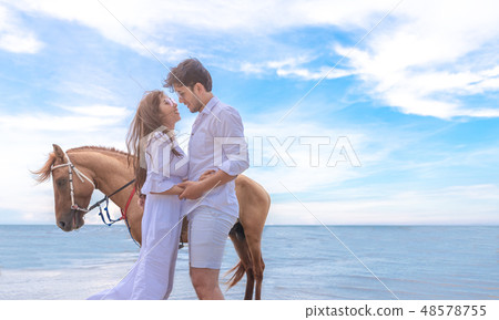 Happy loving couple embracing and kissing outdoors Happy loving couple embracing and kissing outdoors 48578755