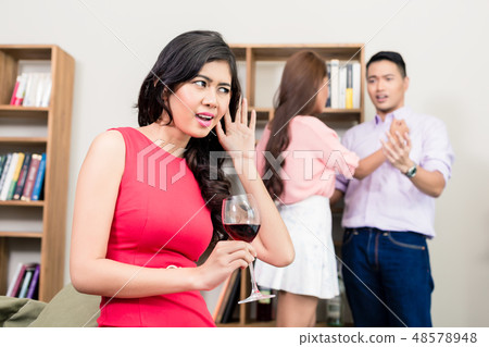 Young woman listening to conversation between couple Young woman listening to conversation between couple 48578948