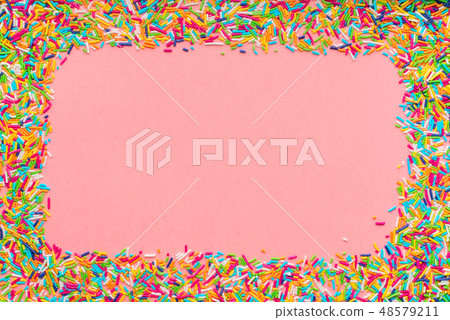 greeting wreath of colorful sprinkles over pink greeting wreath of colorful sprinkles over pink 48579211
