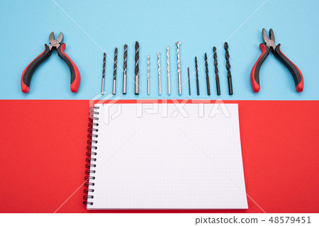 set of metalwork tools with notebook and pen on colorful background 48579451