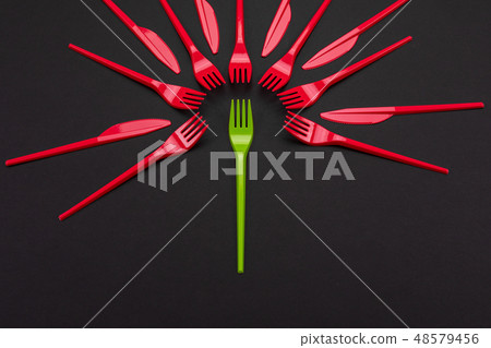 Disposable red and green plastic forks isolated on background 48579456