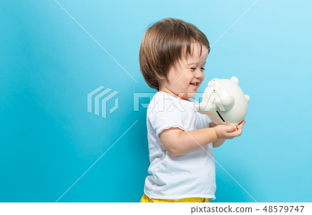 Toddler boy with a piggy bank Toddler boy with a piggy bank 48579747