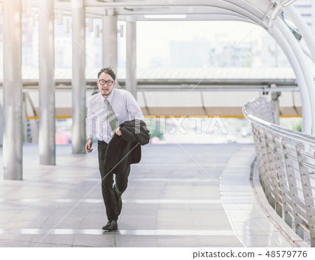 businessman in a hurry and running, he is late businessman in a hurry and running, he is late 48579776