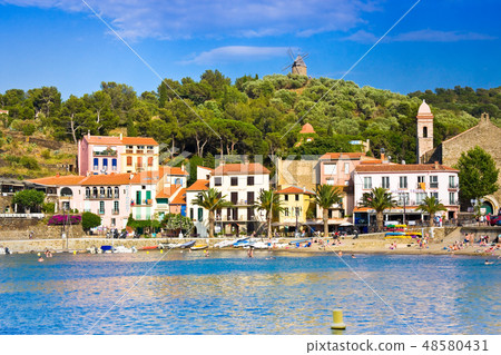 Beach hotels in Collioure village with a windmill 48580431