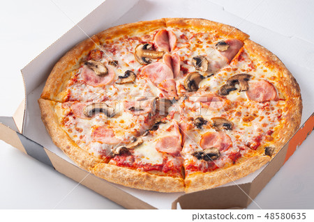 Delicious hot pizza in a box with ham. 48580635