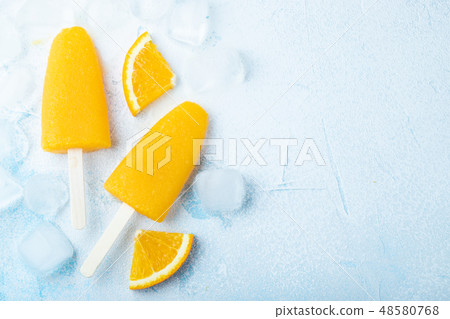Orange popsicles with juice. 48580768