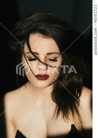 sensual expressive portrait of a girl with disheveled hair and red lipstick 48581721