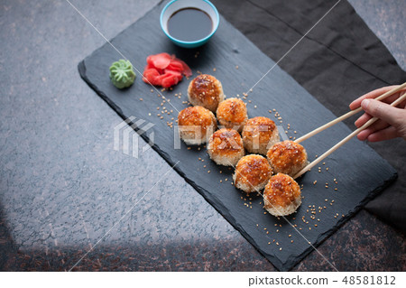 Baked sushi with crab meat. 48581812