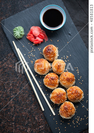 Baked sushi with crab meat. 48581813