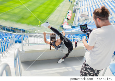 videographer shoots girl on a professional camera. 48582169