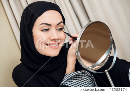 close-up portrait of charming Muslim woman wearing makeup. do face close-up portrait of charming Muslim woman wearing makeup. do face 48582174