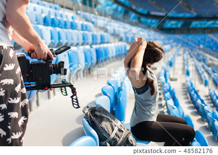videographer shoots girl on a professional camera. videographer shoots girl on a professional camera. 48582176