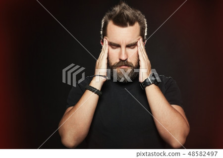 The man suffers from a headache. The man suffers from a headache. 48582497