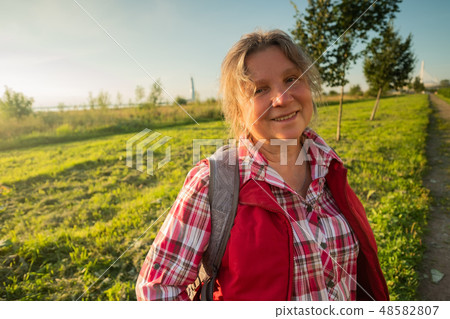 happy older woman standing outside in summer happy older woman standing outside in summer 48582807