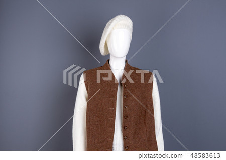 Female white beret and brown waistcoat. 48583613